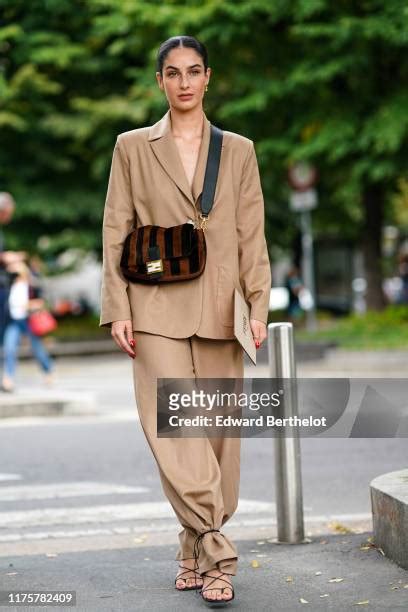 Fiona Zanetti wears a light brown blazer jacket, pants, a brown